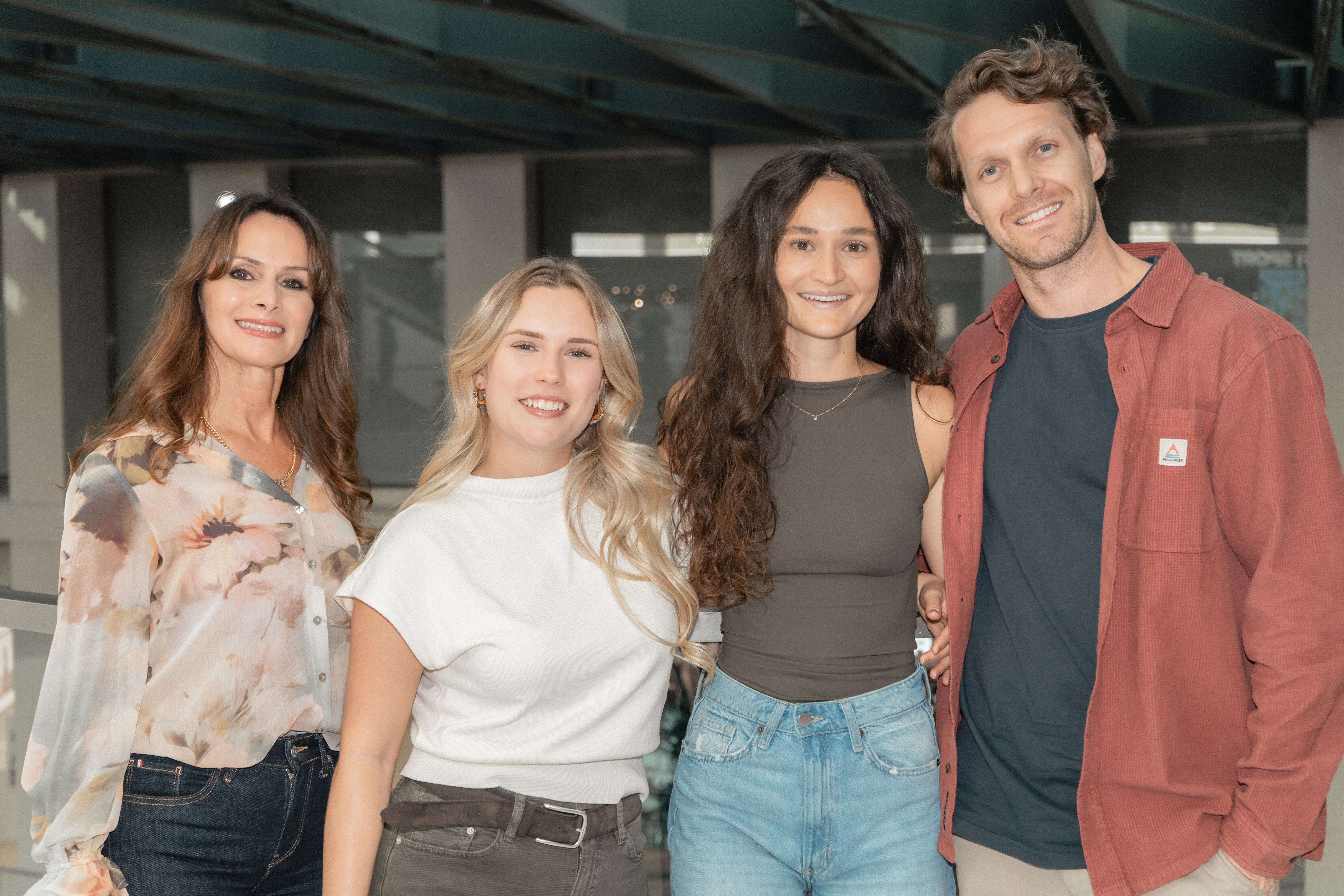 Drei Frauen und ein Mann stehen als Team lächelnd nebeneinander im Innenbereich des Kaufhaus Tyrol.