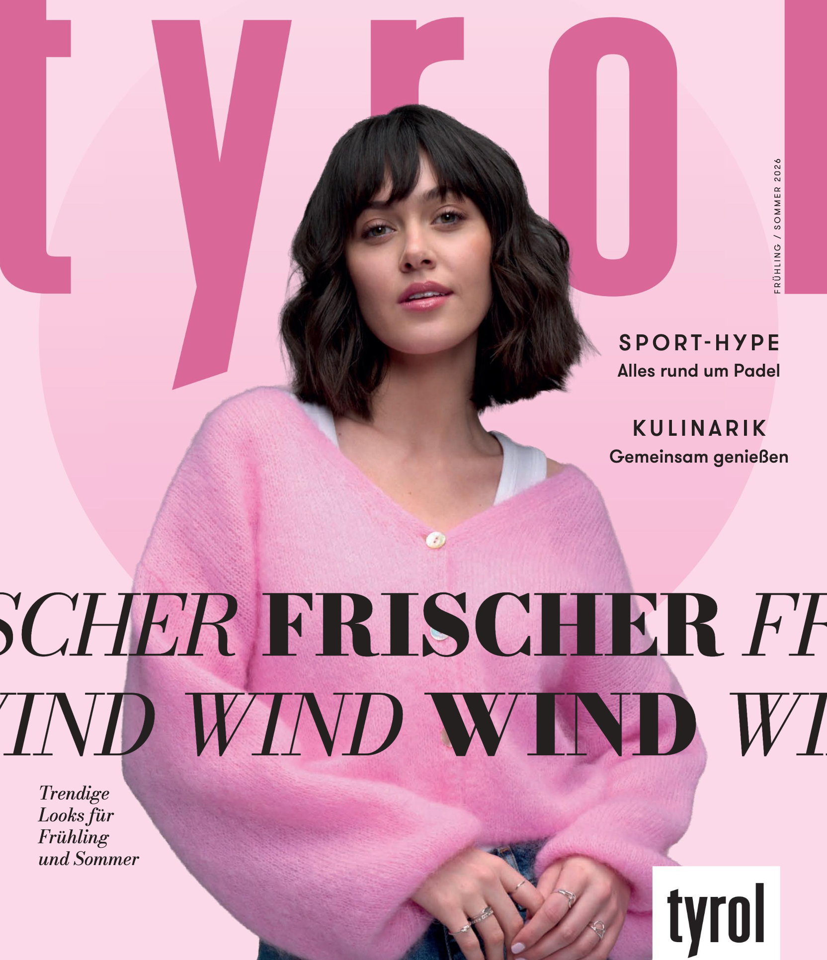 Pinkes Cover des Kaufhaus Tyrol Magazins für Frühling und Sommer mit einer dunkelhaarigen Frau im rosa Strickcardigan und Jeans.